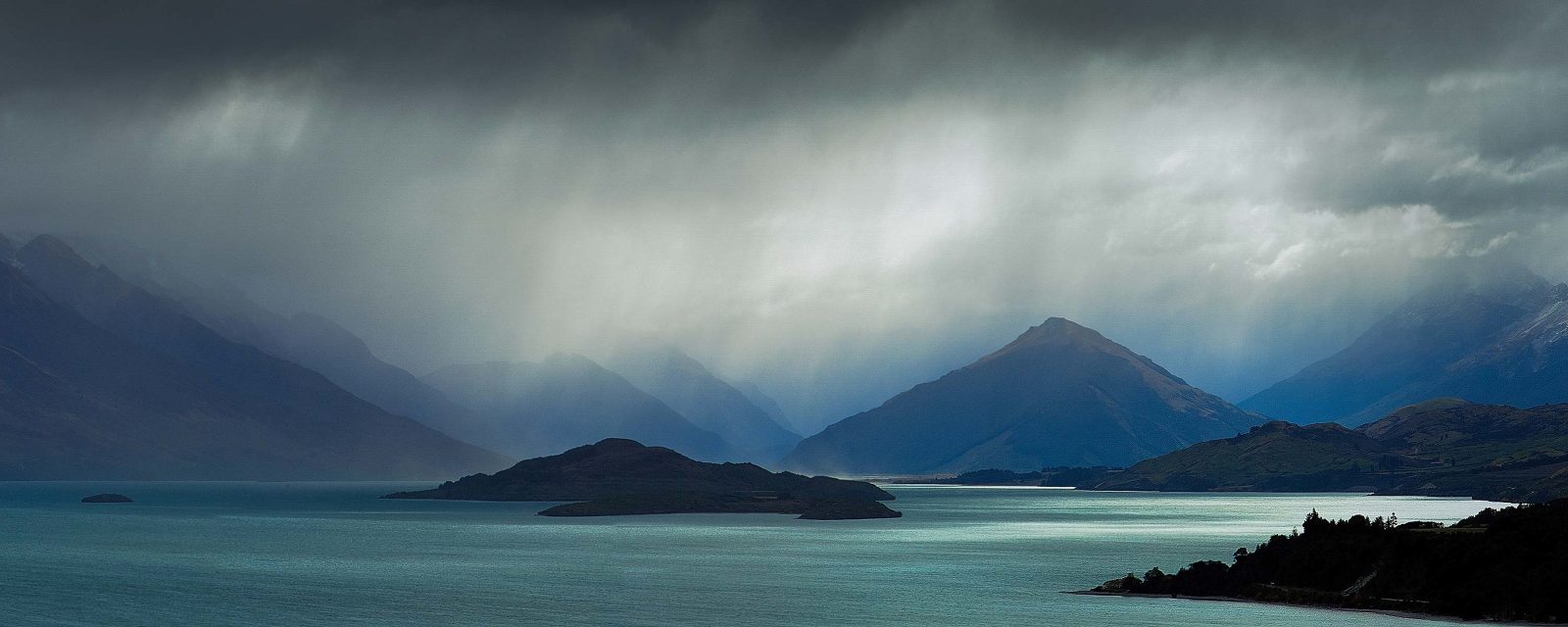 Rays of light over Lake Wakitupu and mountains at Bennetts Bluff