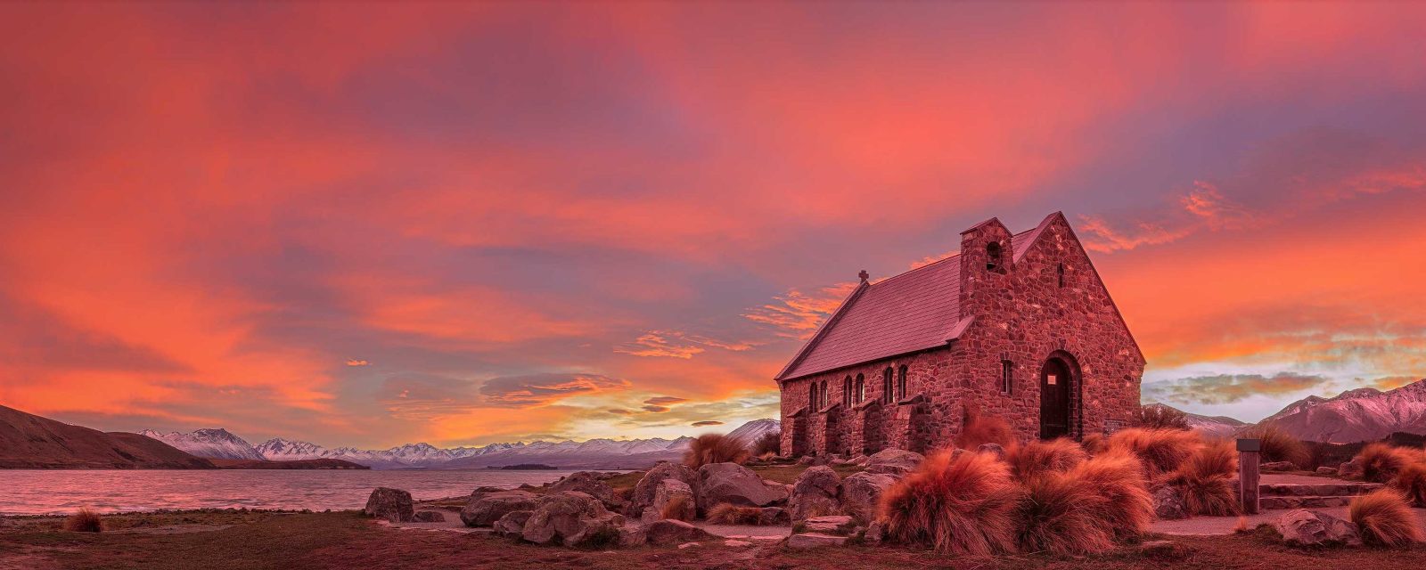 The entire sky is on fire at the Church of the Good Shepherd, lake Tekapo, New Zealand