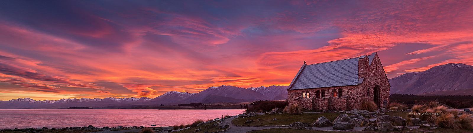 The Church Of the Good Shepherd at Lake Tekapo, New Zealand with the sky exploding with colour at sunrise.